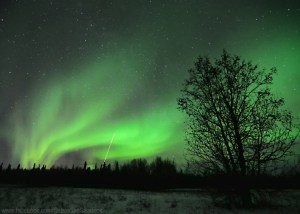 The Northern Lights result from Earth's magnetic field repelling charged particles emitted by the sun.